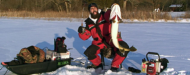 Ice fishing and spearing expert Keith Stanton with a huge Michigan Northern Pike he jigged through the ice on his Pikekilla lure