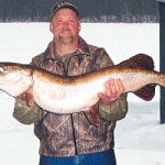 Dan Loyd with a 20 pound gator pike caught through the ice. Credit: Jack Payne