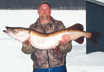 Dan Loyd with a 20 pound gator pike caught through the ice. Credit: Jack Payne