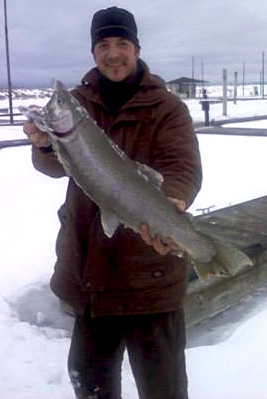 K&E Stopper Lures Pro Staff member Ray Tiffany of the HARD WATER MANIACS with a giant light line buck rainbow trout