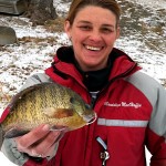 The other half of team Hard Water Maniacs, Mandy MacHaffie shows off a big bull bluegill caught through the ice