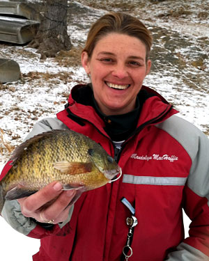 The other half of team Hard Water Maniacs, Mandy MacHaffie shows off a big bull bluegill caught through the ice