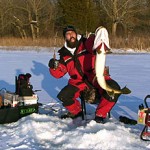 Keith Stanton with a giant Northern Pike he jigged through the ice from a Michigan lake