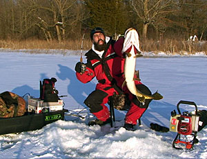 Keith Stanton with a giant Northern Pike he jigged through the ice from a Michigan lake