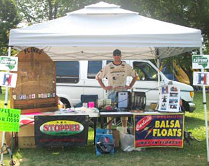 Raymond Tiffany works the Hard Water Maniacs booth at the July 2012 Community Fest