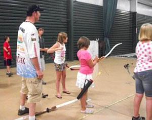 Ray Tiffany works with youth at free Hard Water Maniacs archery courses