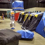 Ice fishing shanties and shelters are lined up, even floating in the air for the 2013 Ultimate Fishing Show Detroit ice extravaganza.