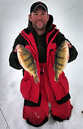 Josh Clawson with two North Dakota jumbo ice fishing caught yellow perch