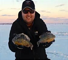 Sportsmens Direct store manager Justin Clark shows off a couple beautiful Lake St. Clair ice-caught panfish.
