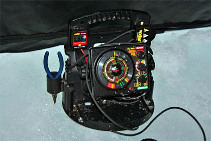 Ice fishing expert Dan Zatarga uses a flasher to verify the depth of his lure and to watch for approaching whitefish. Photo Credit: Jeff Nedwick