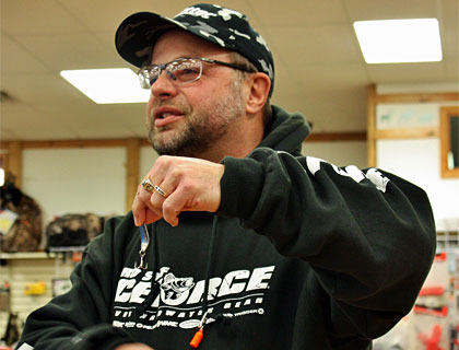 Ice fishing school leader Mark Martin demonstrates the proper way to position a treble hook on a jigging spoon