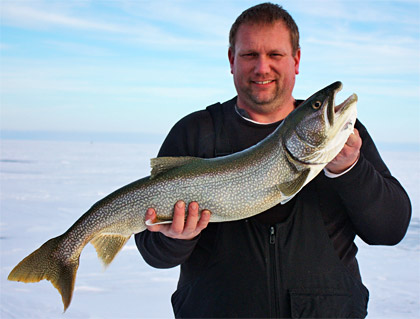 Mark Martin pro-staffer Vern Meehle shows off a bonus lake trout jigged through the ice from Saginaw Bay