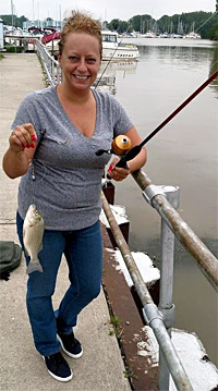 Michelle Devera lands a white bass on a K&E Tackle No Tangle Rig