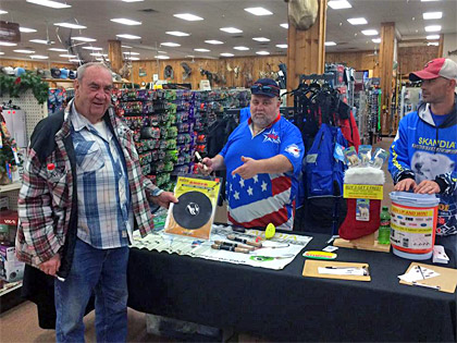 A customer checks out the K & E Tackle Auger Adapter while visiting the ice fishing table at Jay's Ice Day