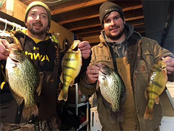 Two ice fishing anglers with big crappie and perch