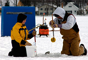 Ice anglers checking a tip-up to see what they caught