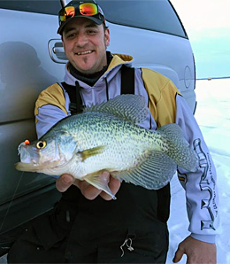 Ray Tiffany shows off a big late ice crappie caught jigging early